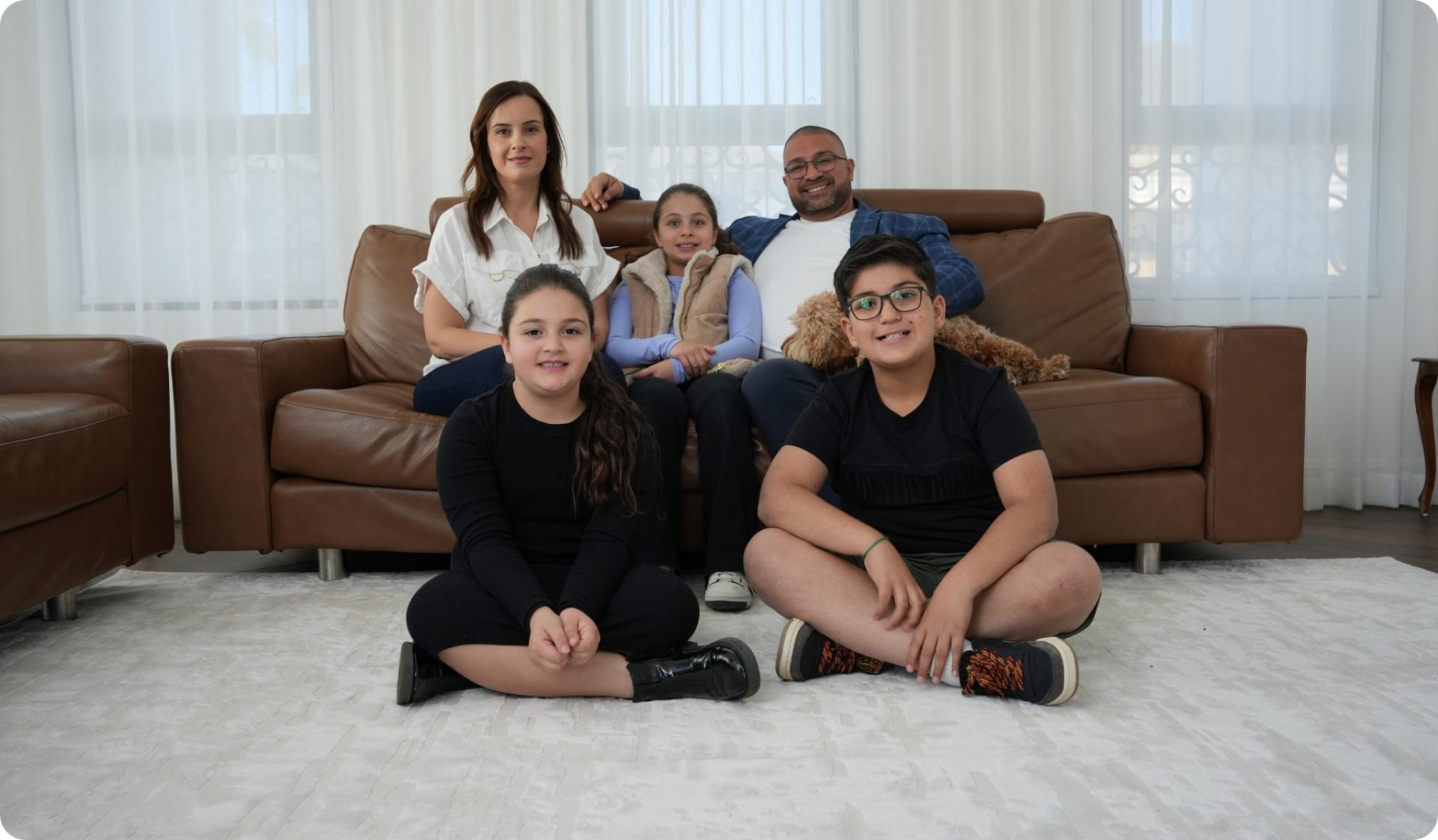 An Australian family relaxing at home, the kind of family Malv Consulting helps invest for the long term.